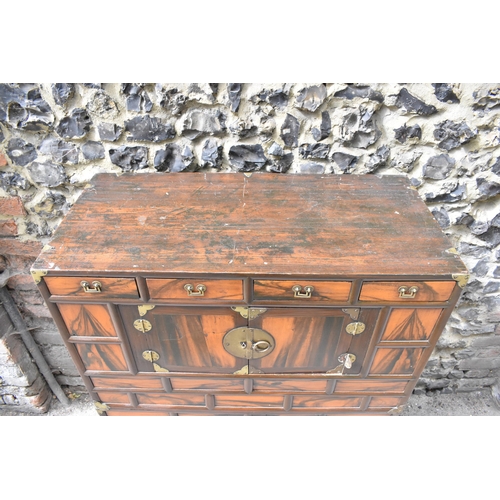 148 - A Korean 19th century two part Tansu cabinet, with brass brackets and handles, with a figured veneer... 