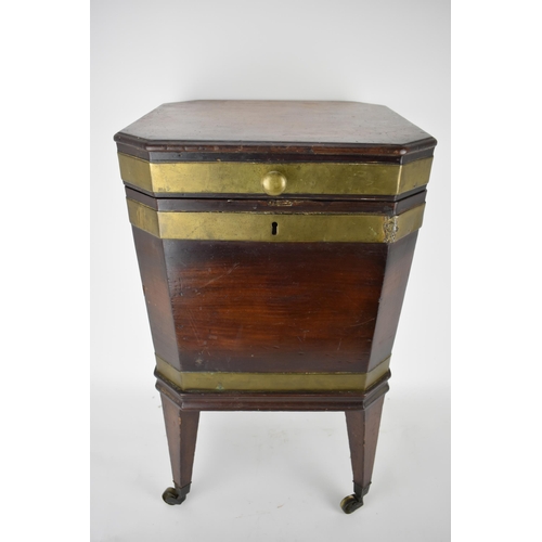 171 - A George III mahogany square cellaret with brass banding, a hinged lid and canted corners, enclosing... 