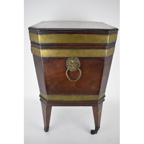 171 - A George III mahogany square cellaret with brass banding, a hinged lid and canted corners, enclosing... 