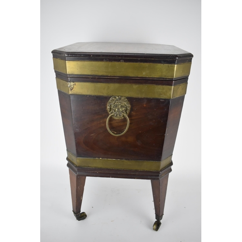 171 - A George III mahogany square cellaret with brass banding, a hinged lid and canted corners, enclosing... 