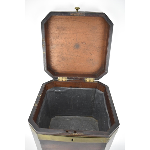 171 - A George III mahogany square cellaret with brass banding, a hinged lid and canted corners, enclosing... 