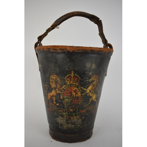 173 - A 19th century leather and canvas fire bucket with an armorial device, and a leather carrying handle... 