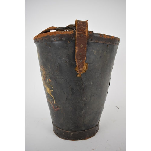 173 - A 19th century leather and canvas fire bucket with an armorial device, and a leather carrying handle... 