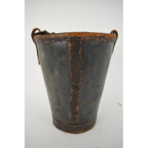 173 - A 19th century leather and canvas fire bucket with an armorial device, and a leather carrying handle... 