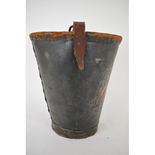 173 - A 19th century leather and canvas fire bucket with an armorial device, and a leather carrying handle... 