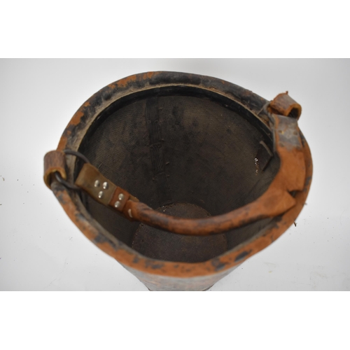 173 - A 19th century leather and canvas fire bucket with an armorial device, and a leather carrying handle... 