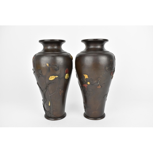 20 - A pair of Japanese Meiji period patinated bronze vases, of tapered form with naturalistic relief dec... 