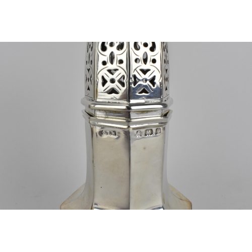 200 - An early 20th century silver sugar sifter of a baluster form with pierced lid, hexagonal body, raise... 