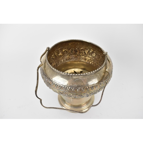 228 - An Indian silver ice bucket with a swing handle, a bulbous upper section and tapered sides, embossed... 