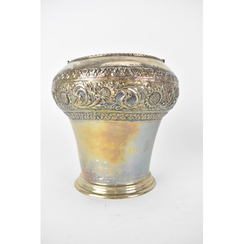 228 - An Indian silver ice bucket with a swing handle, a bulbous upper section and tapered sides, embossed... 