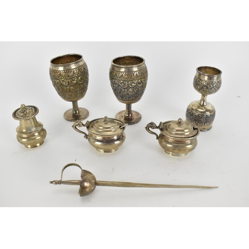 229 - Indian silver - comprising three piece condiment set, stamped sterling silver, two small goblets emb... 