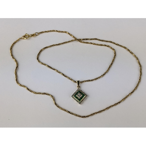 230 - A 9ct gold pendant set with diamonds and green stones, possibly emeralds, 1.2g, on an 18ct gold chai... 