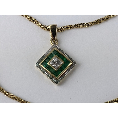 230 - A 9ct gold pendant set with diamonds and green stones, possibly emeralds, 1.2g, on an 18ct gold chai... 