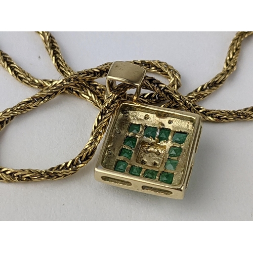 230 - A 9ct gold pendant set with diamonds and green stones, possibly emeralds, 1.2g, on an 18ct gold chai... 