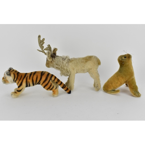 236 - A Steiff seal with a label 17cm high, a reindeer 24cm high to top of antler, a tiger 28cm l
Conditio... 