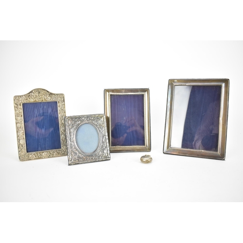 239 - Four late 20th century silver photograph frames, two with embossed decoration, the largest 21cm x 16... 