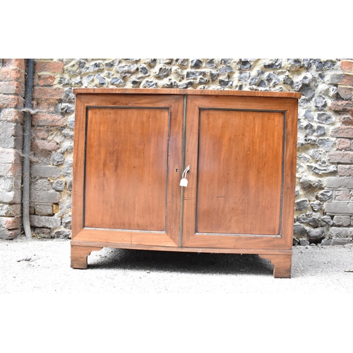 240 - An early 19th century mahogany chest with a galleried top over a pair of panelled doors, enclosing t... 