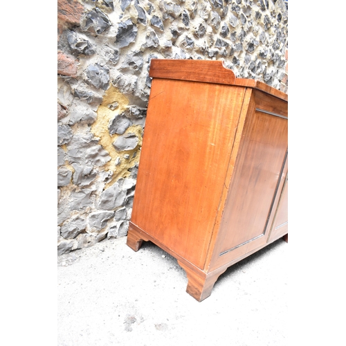 240 - An early 19th century mahogany chest with a galleried top over a pair of panelled doors, enclosing t... 