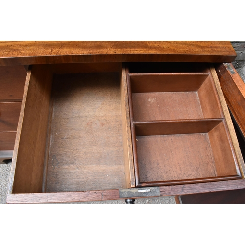 240 - An early 19th century mahogany chest with a galleried top over a pair of panelled doors, enclosing t... 