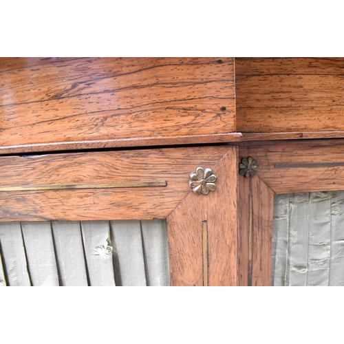 241 - A Regency brass string inlaid rosewood breakfront cabinet, with a mottled green marble top, over fou... 