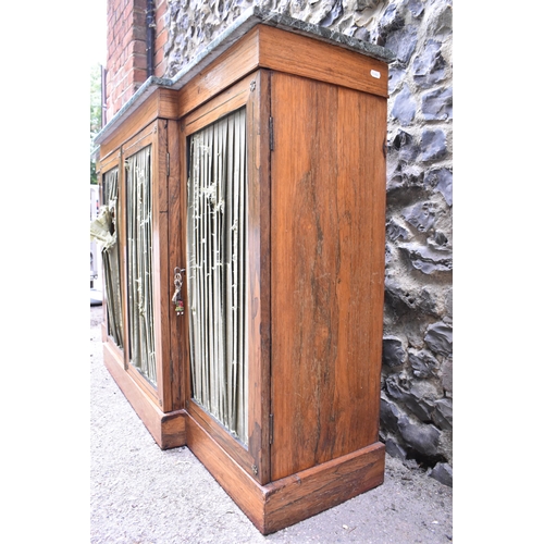 241 - A Regency brass string inlaid rosewood breakfront cabinet, with a mottled green marble top, over fou... 