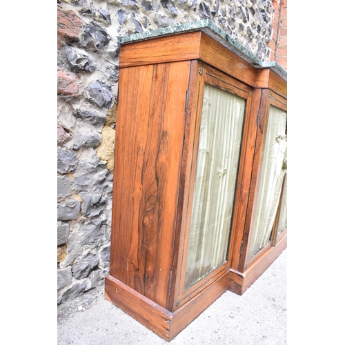 241 - A Regency brass string inlaid rosewood breakfront cabinet, with a mottled green marble top, over fou... 