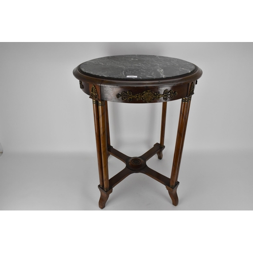 242 - An early 19th century French walnut table with gilt metal mounts and an inset mottled green marble t... 