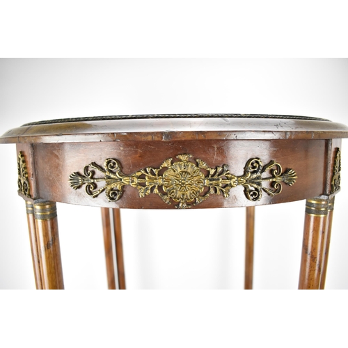 242 - An early 19th century French walnut table with gilt metal mounts and an inset mottled green marble t... 