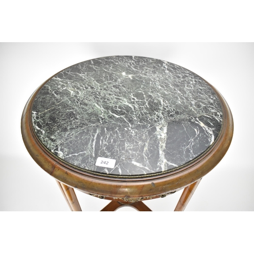 242 - An early 19th century French walnut table with gilt metal mounts and an inset mottled green marble t... 