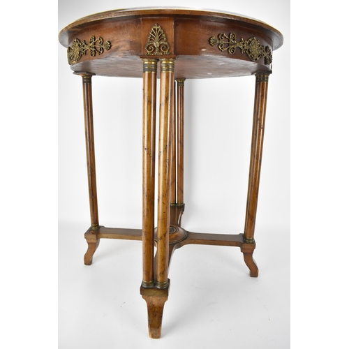 242 - An early 19th century French walnut table with gilt metal mounts and an inset mottled green marble t... 