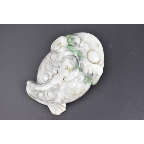 27 - A Chinese mottled green jade model of a toad, with detail to the back and pierced hole to the front ... 