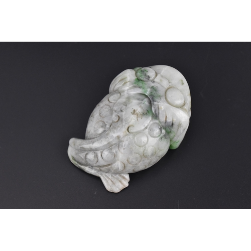 27 - A Chinese mottled green jade model of a toad, with detail to the back and pierced hole to the front ... 