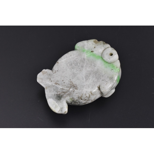 27 - A Chinese mottled green jade model of a toad, with detail to the back and pierced hole to the front ... 