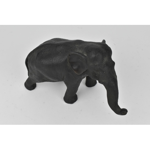 28 - A Japanese Meiji period patinated bronze model of an elephant, realistically rendered with textured ... 