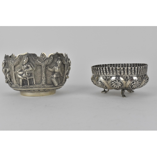 62 - Two early 20th century Indian silver bowls, the larger one decorated with panels of figures beneath ... 