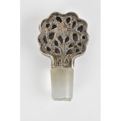 66 - An early 20th century Persian white metal clad glass bottle with a tapered neck, the covering pierce... 