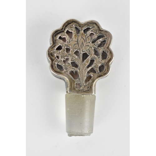 66 - An early 20th century Persian white metal clad glass bottle with a tapered neck, the covering pierce... 