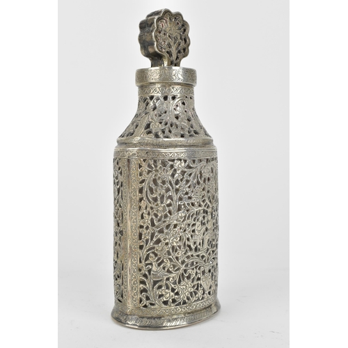 66 - An early 20th century Persian white metal clad glass bottle with a tapered neck, the covering pierce... 