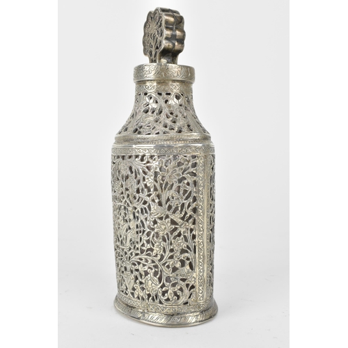 66 - An early 20th century Persian white metal clad glass bottle with a tapered neck, the covering pierce... 