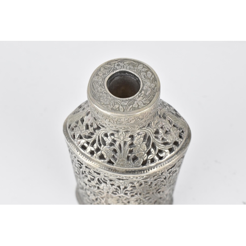 66 - An early 20th century Persian white metal clad glass bottle with a tapered neck, the covering pierce... 