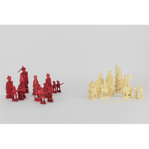 70 - A late 19th/early 20th century Chinese red stained and natural carved ivory chess set, modelled as E... 