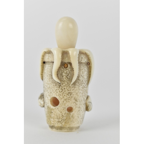 77 - A Japanese Meiji period, late 19th century ivory netsuke of an octopus in a basket with an articulat... 