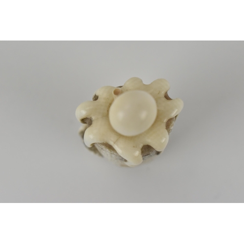 77 - A Japanese Meiji period, late 19th century ivory netsuke of an octopus in a basket with an articulat... 