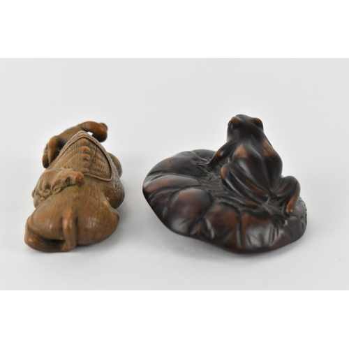 81 - Two early 20th century Japanese wood netsuke of a recumbent water buffalo and its offspring, signed ... 