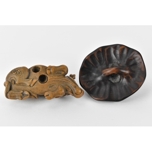 81 - Two early 20th century Japanese wood netsuke of a recumbent water buffalo and its offspring, signed ... 