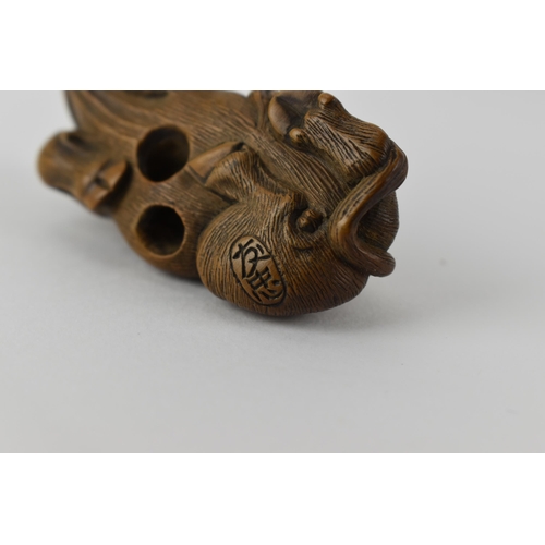 81 - Two early 20th century Japanese wood netsuke of a recumbent water buffalo and its offspring, signed ... 