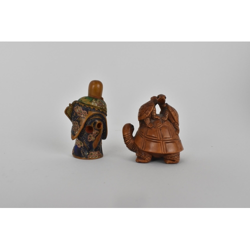 82 - A Quin dynasty and a later wooden netsuke of a deity wearing a robe and holding a fan with painted d... 