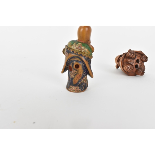 82 - A Quin dynasty and a later wooden netsuke of a deity wearing a robe and holding a fan with painted d... 