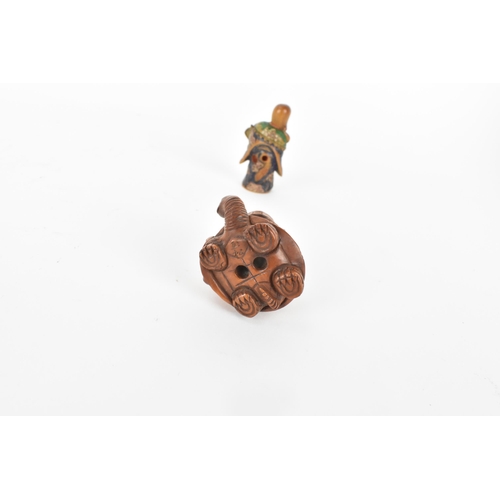 82 - A Quin dynasty and a later wooden netsuke of a deity wearing a robe and holding a fan with painted d... 