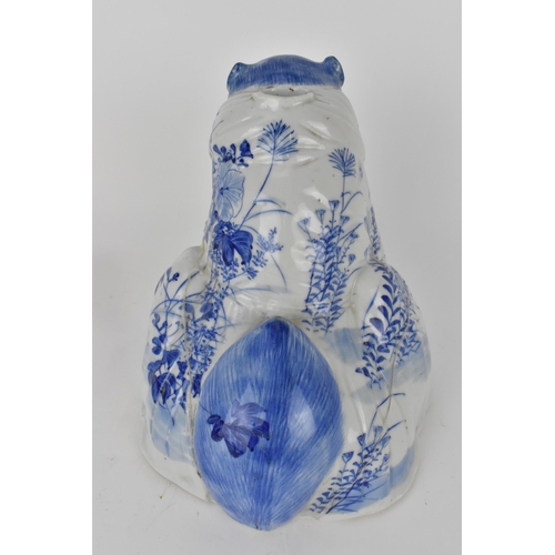 83 - An early 20th century Japanese blue and white incense burner in the form of a bear, decorated with f... 